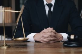 Business and lawyers discussing contract papers with brass scale on desk in office. Law, legal services, advice, justice and law concept